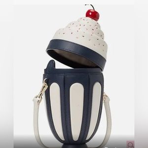 The Kate Spade Sunday bag has a wallet. The wallet is not Kate Spade.